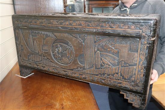 A Chinese carved camphorwood trunk W.90cm